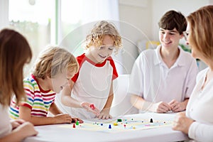 Family playing board game. Kids play