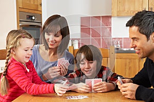 Family Playing Cards In Kitchen