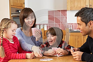 Family Playing Cards In Kitchen