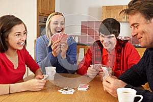 Family Playing Cards In Kitchen