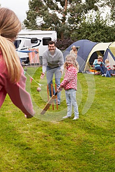 Family Playing Cricket Match On Camping Holiday