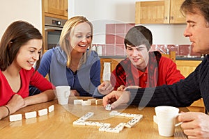 Family Playing Dominoes In Kitchen