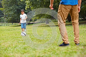 Family playing football. Father and son having fun.