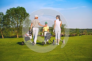 Family playing golf