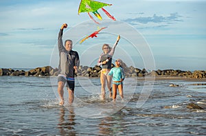 Family playing with kite in a summer vacation