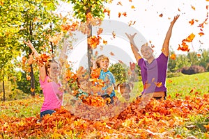 Family playing with leaves and throwing them