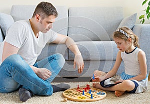 Family playing ludo.