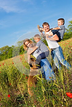 Family playing on the meadow