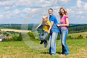 Family playing on meadow in summer