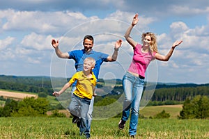 Family playing on meadow in summer