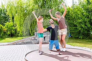 Family playing miniature golf