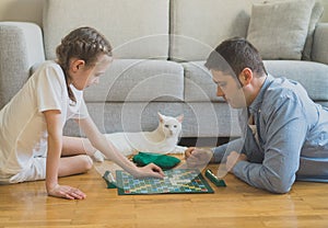 Family playing scrabble board game. photo