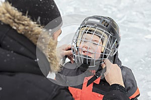 A family playing at the skating rink in winter