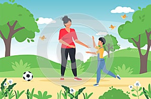 Family Playing Soccer In Park Together. Mother spending leisure summer time outdoors playing with children.