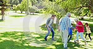 Family playing soccer together