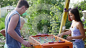 Family playing table football outdoors.Fun outdoors