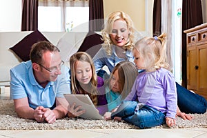 Family playing with Tablet computer at home