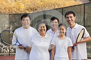 Family playing tennis, portrait