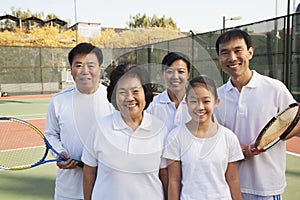 Family playing tennis, portrait