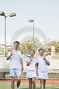 Family playing tennis, portrait