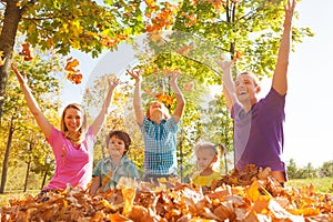 Family playing and throwing leaves in the air