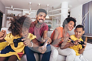 Family playing video games together and having fun at home