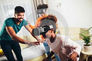 Family playing video games with VR glasses