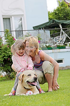 Family plays with a dog