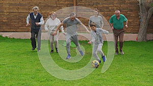 Family plays football at home on the meadow. The concept of family, sport and a healthy lifestyle.