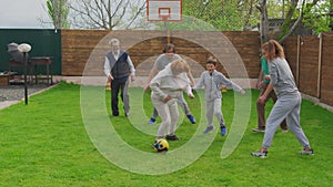 Family plays football at home on the meadow. The concept of family, sport and a healthy lifestyle.