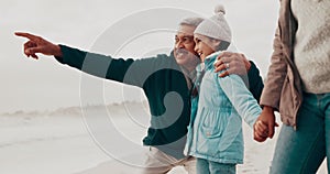 Family, pointing and girl with grandparents at beach with sunset on vacation, holiday and relaxing. Nature, travel and