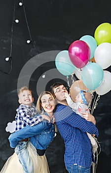 Family portrait with balloons in the studio