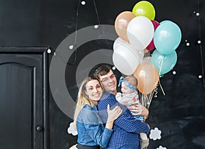 Family portrait with balloons in the studio