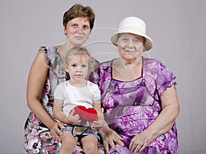 Family portrait of the child, grandmother and great-grandmother