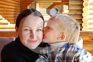 Family portrait the child kissing mum