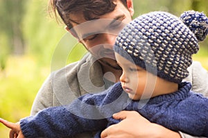 Family portrait. Father play with his child. Father holding a child in his arms. They are happy. Happy family walking outdoor