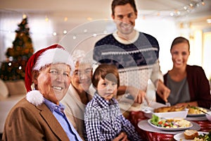 Family, portrait and grandparents at dinner on Christmas, together with food and celebration in home. Happy, event and