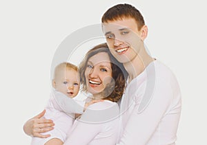 Family portrait of happy smiling mother, father and baby over white background
