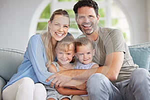 Family portrait, man and woman with children bonding in house living room, home interior and lounge sofa. Happy smile