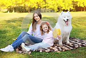 Family portrait, pretty young mother and child walks with dog