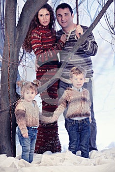 Family portrait standing on studio snow forest background