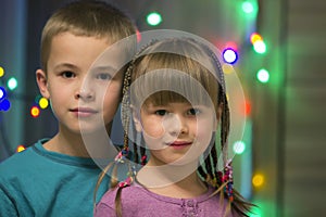 Family portrait of two young happy cute blond children, handsome boy and girl with lot of long braids, brother and sister smiling