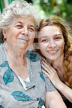 Family portrait of young woman and her grandmother