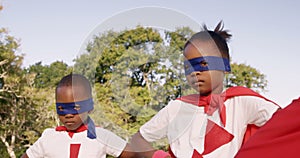 Family posing in costume of superheroes