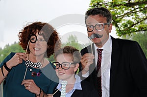 Family posing in front of a photo booth