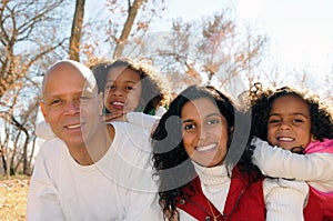 Family posing in park setting