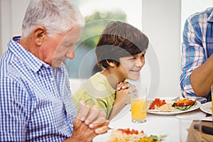 Family praying together before meal