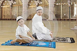 Family praying together in the mosque