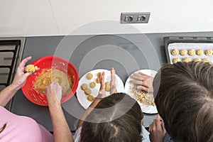 Family preparing sweets in the kitchen photo