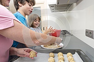 Family preparing sweets in the kitchen photo